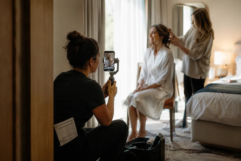 Woman filming bridal getting-ready moments as a wedding content creator